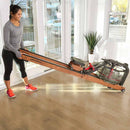 Female lifting and moving Row HX Rower on front wheels