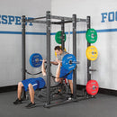 Exercisers bench pressing on Hammer Strength power rack with Urethane Bumper plates