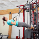 Woman exercising with TRX suspension trainer attached to Life Fitness machine
